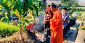 Family and Monk at Grave